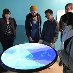 students use a digital interactive table showing a map